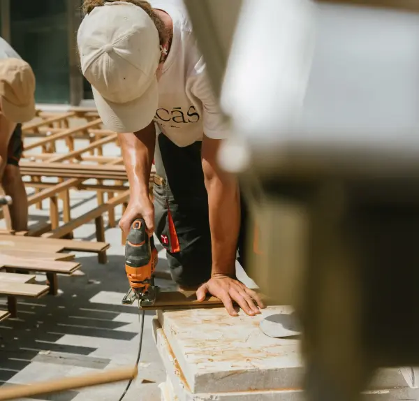 Worker cutting a board with a jigsaw on a job site