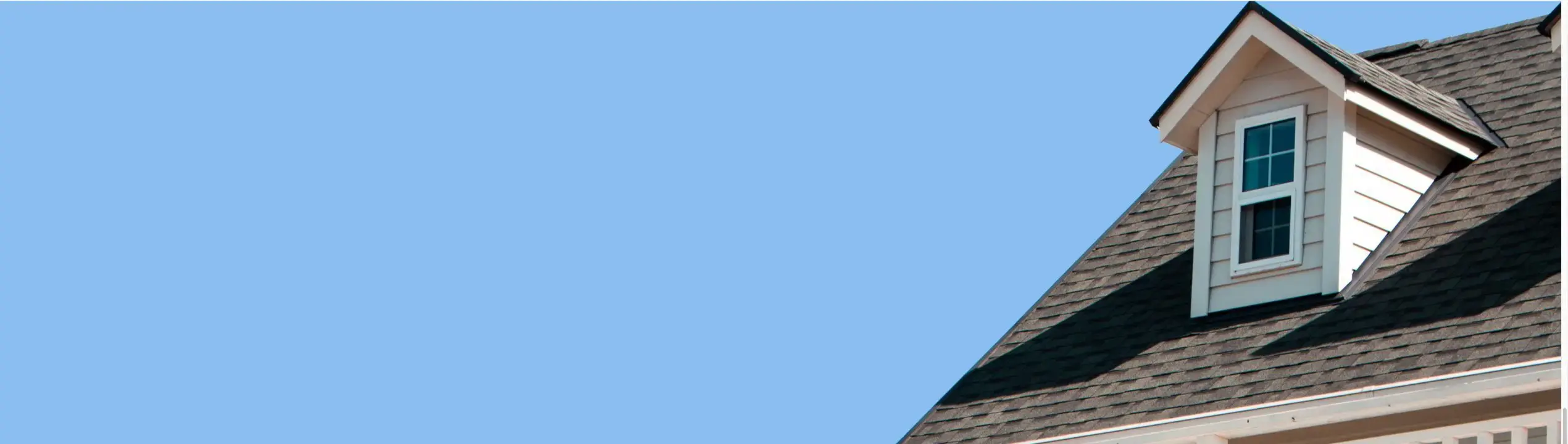 Roof dormer against a blue sky