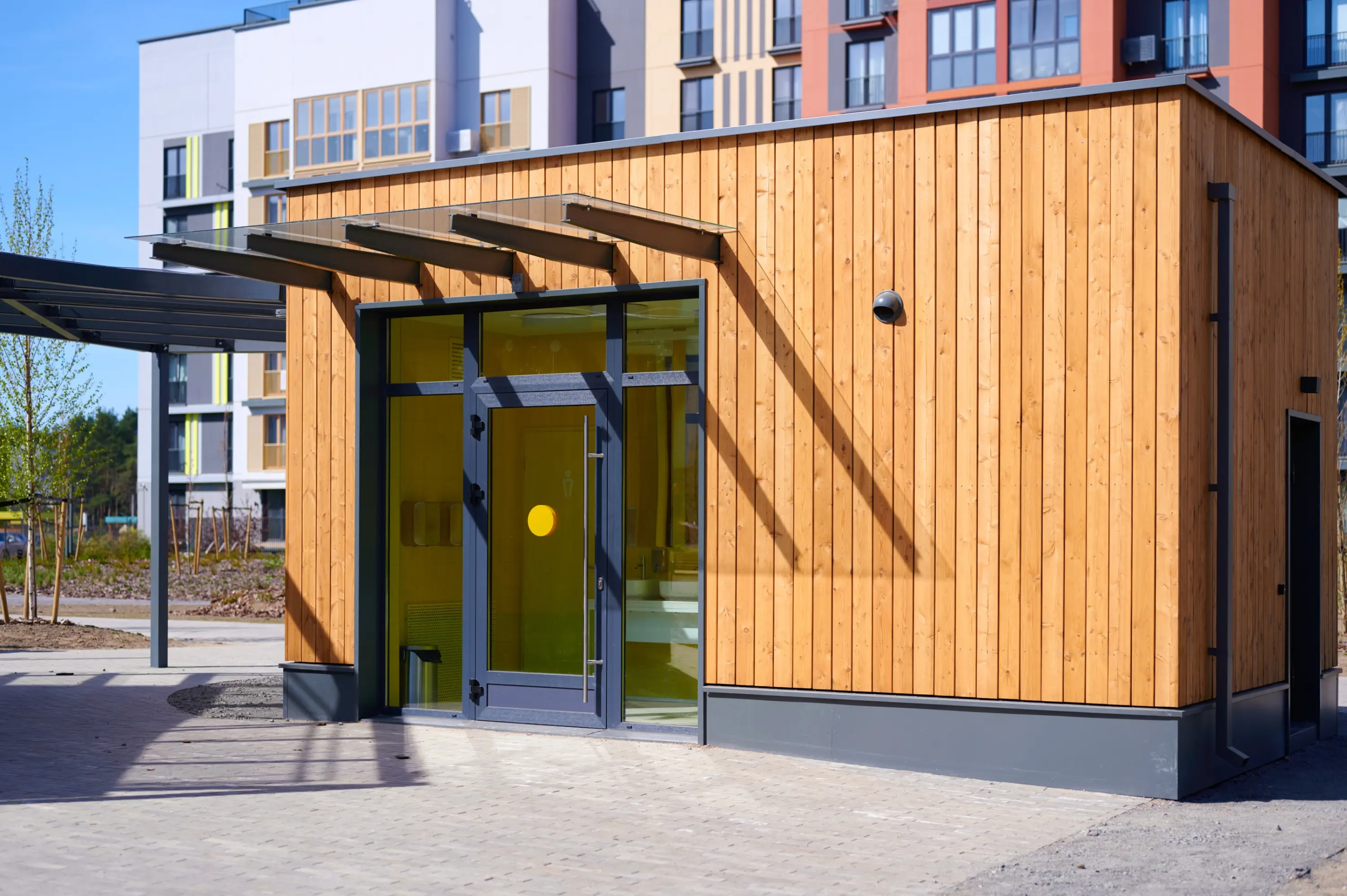 Modern commercial building entrance clad in wooden vertical siding