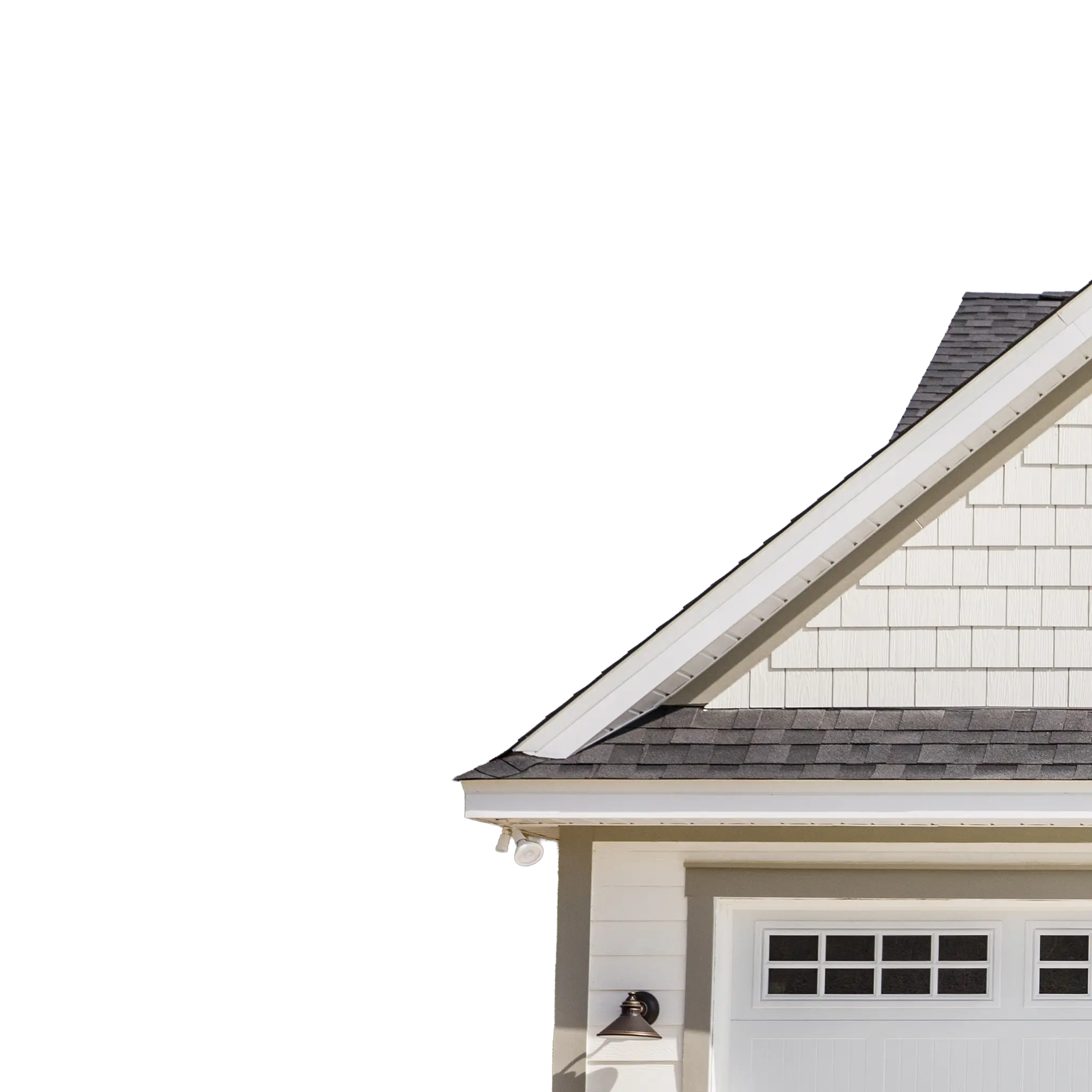 White house gable above a double garage door against a blue sky