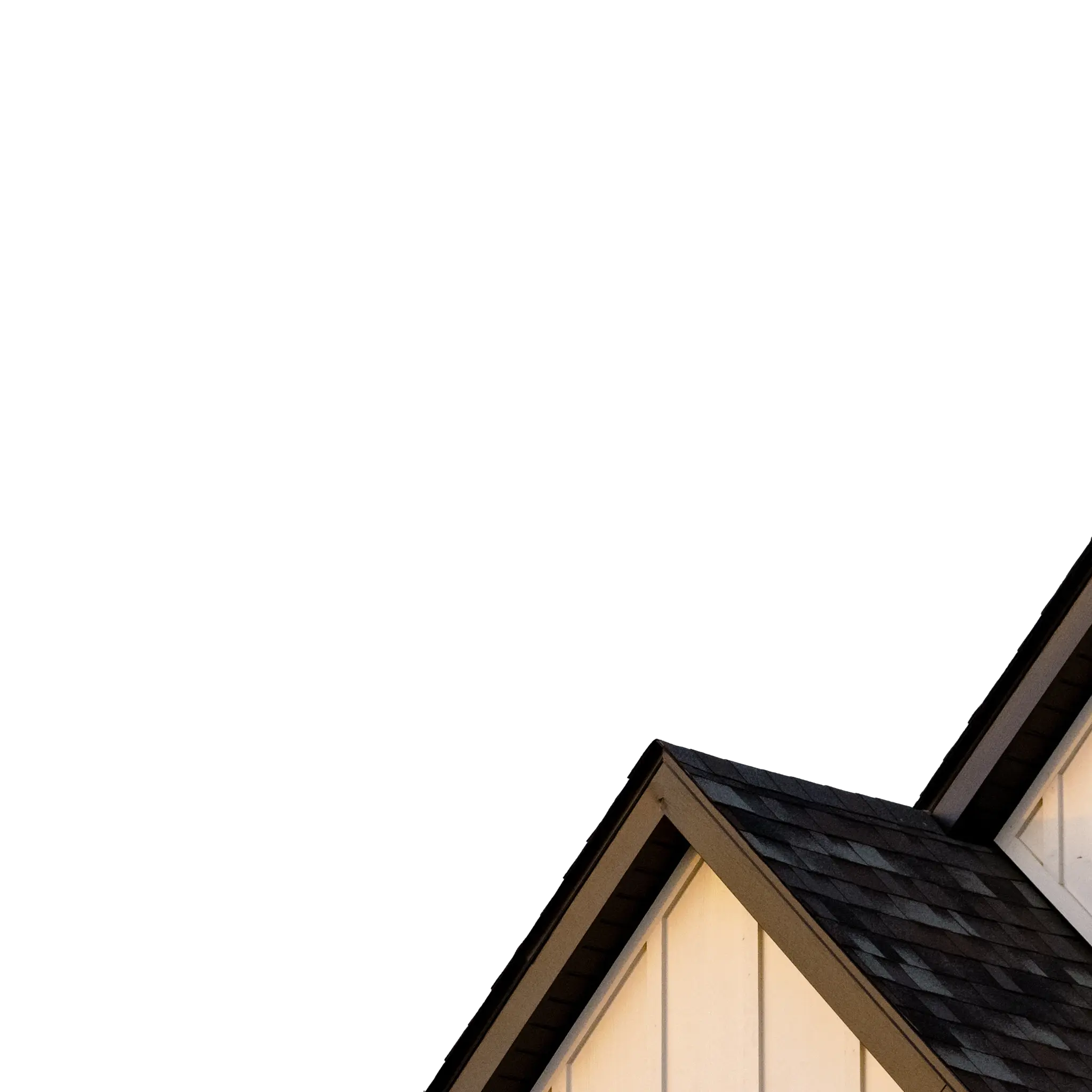 White board-and-batten house gables with dark shingles against a blue sky