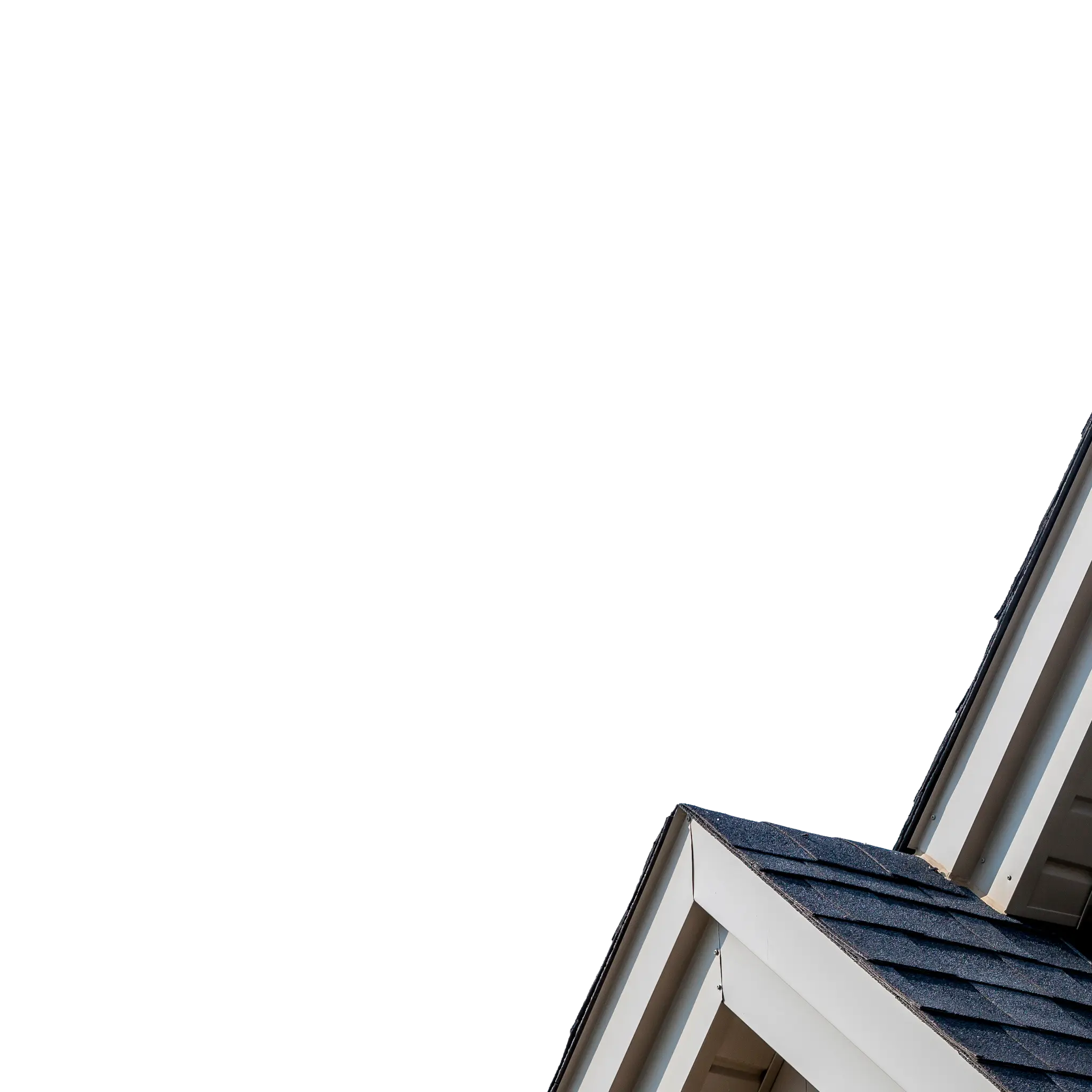 House gable with grey shingle siding and white trim against a blue sky
